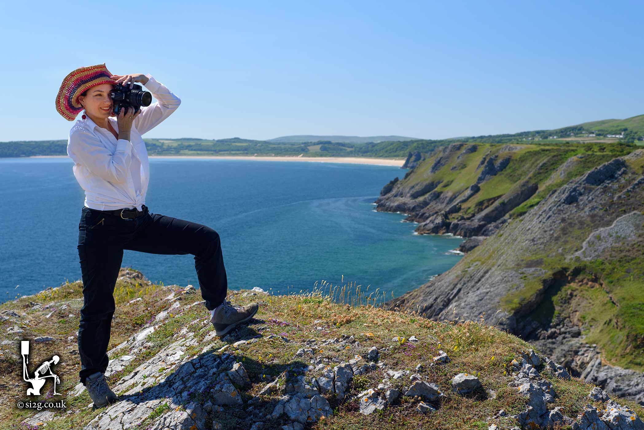 Sun, Sea and Sand - The Welsh coastal path is interesting and diverse.  This beautiful cliff-top location is on the Gower Peninsular.  A tourist can be seen taking a photograph with Oxwich Bay in the distance.