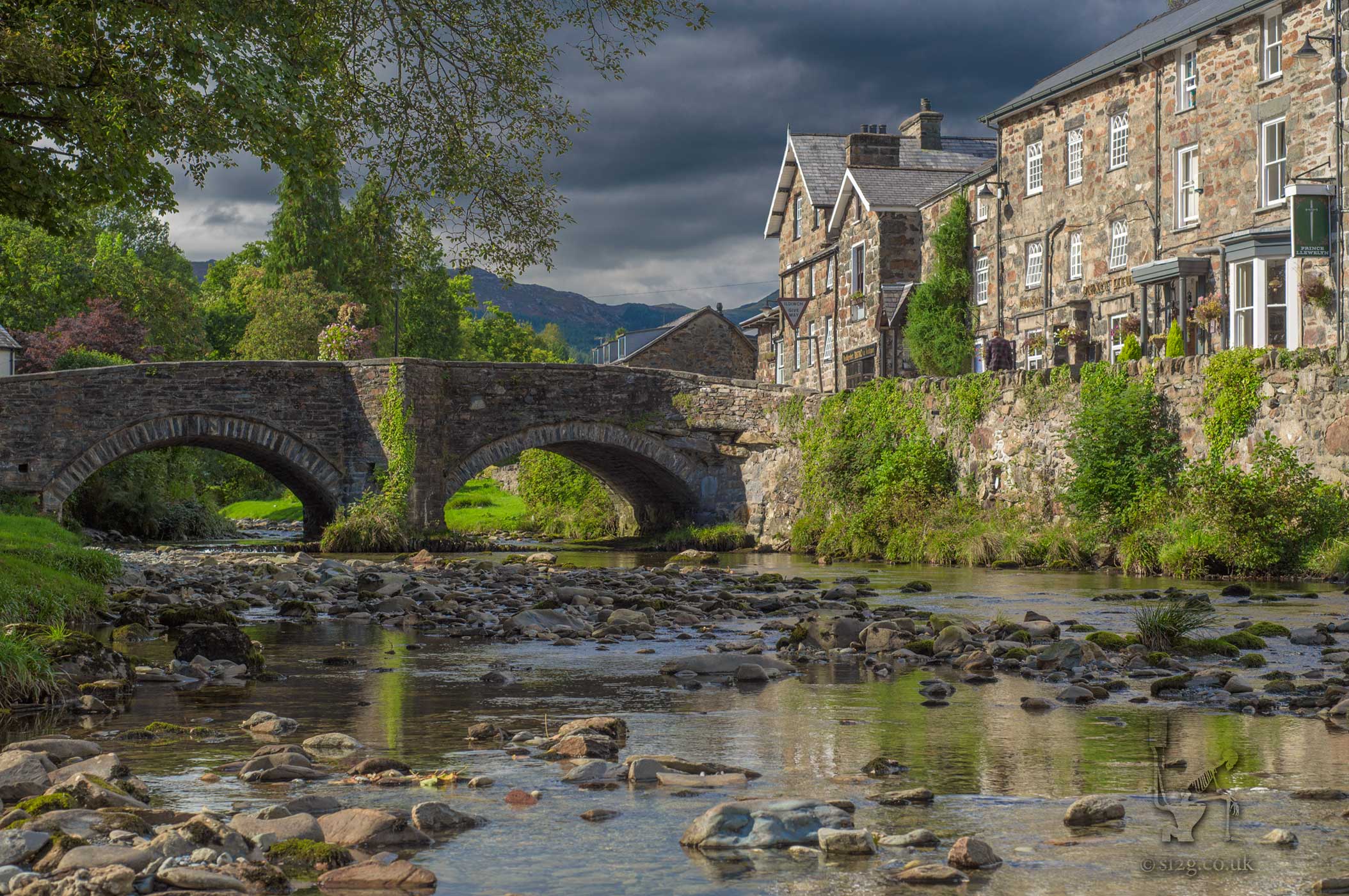 Chocolate Box Village - This picturesque stone bridge and country pub is situated in the village of Beddgelert in Snowdonia, Wales.  Wanting to get an edge over the other photographers milling around that day, I decided to climb over the stone wall paddle about in the river to get that chocolate box image of serenity with no cars or people in shot.